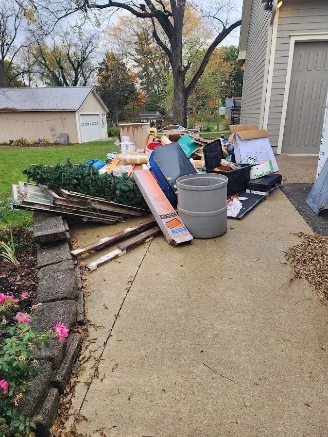 Dumpster being loaded with debris for Roofing Dumpster Rental in Makakilo